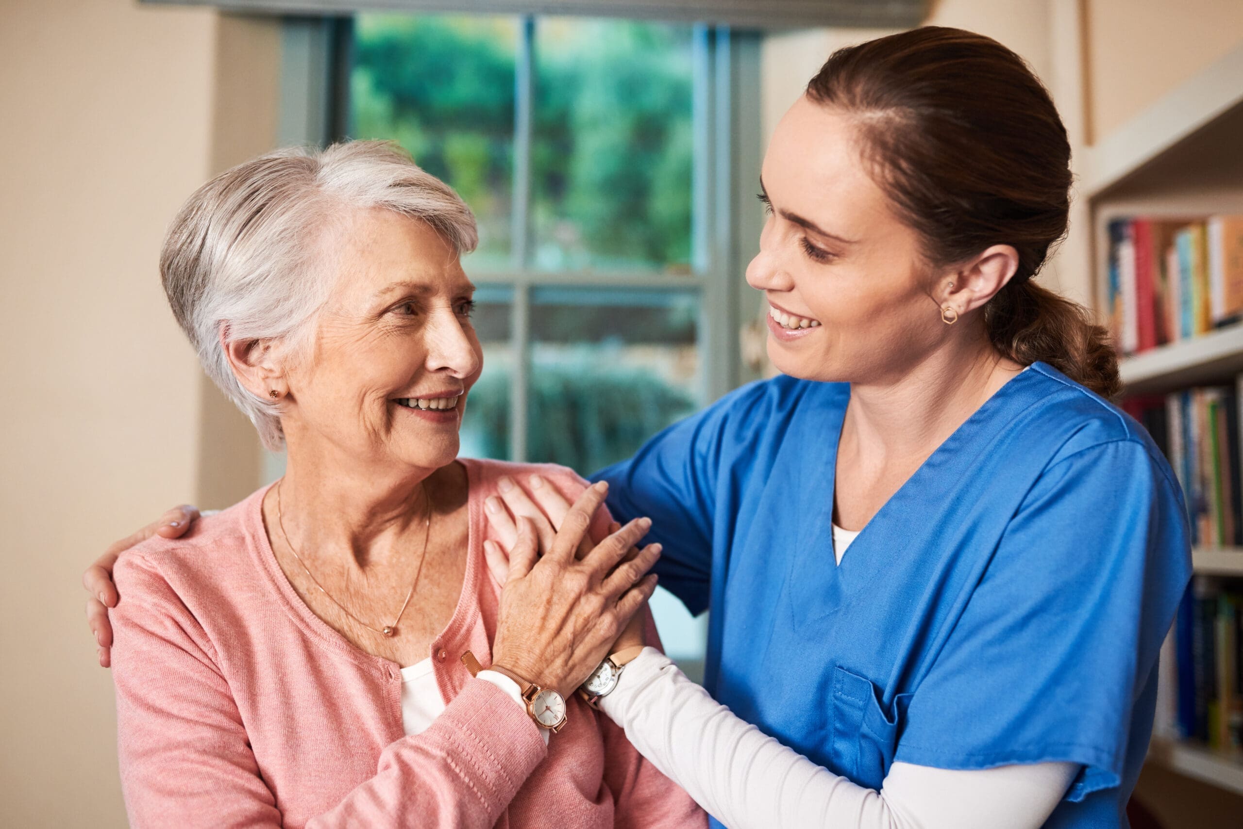 Nurse, senior woman and smile with support at retirement home, helping hand and trust of medical wellness. Happy, people and caregiver with gratitude, respect and healthcare advice in living room