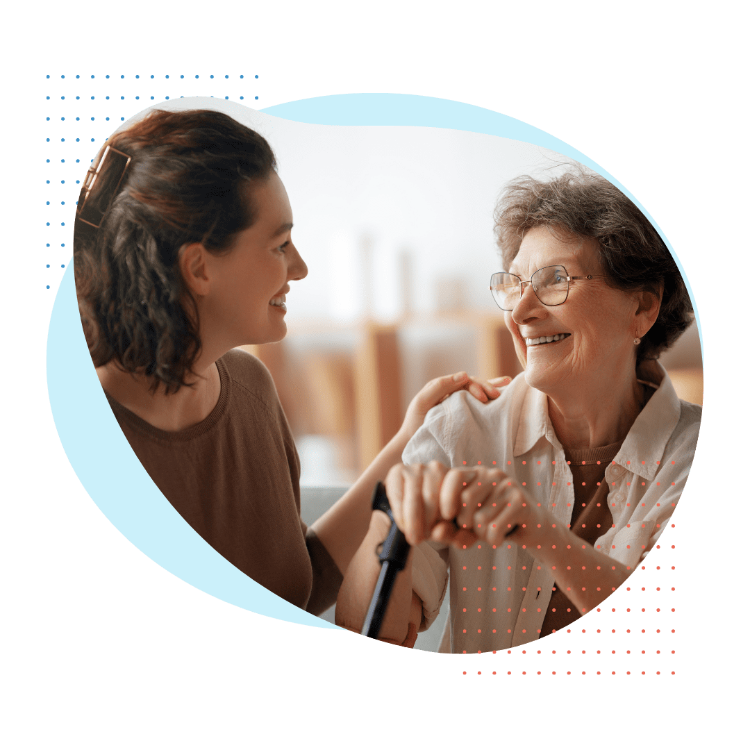 A polished female Best Care consultant in business attire, actively pointing to and explaining long-term care insurance policy documents to an elderly couple seated at a large, modern marble table in a luxurious Bal Harbour residence.