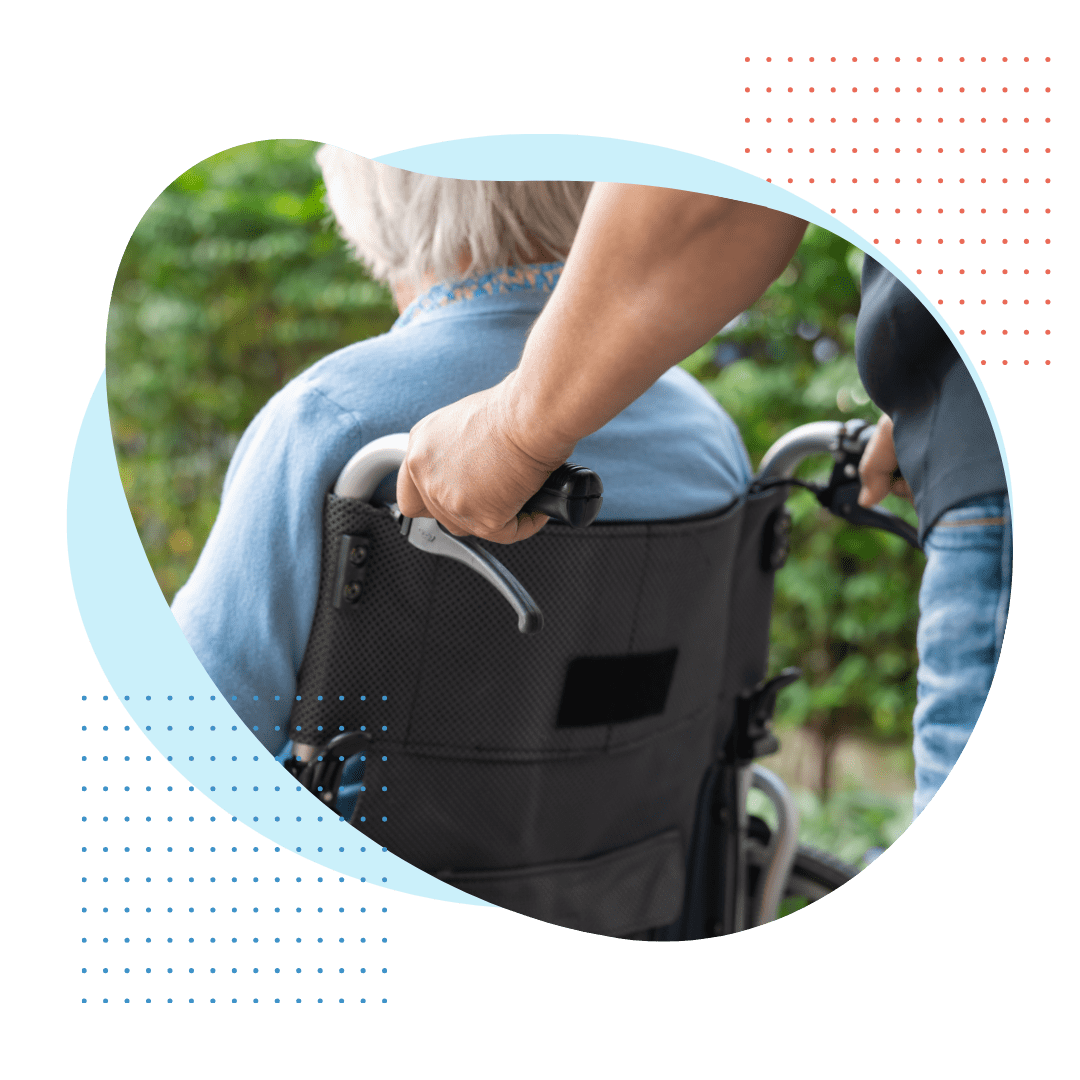man pushing woman in wheelchair